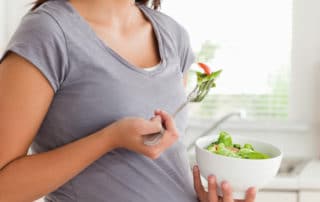 A pregnant woman showing her satisfaction after receiving dental treatment from Pike District Smiles.