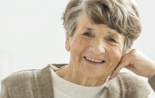 Grandma posing with a beautiful smile, radiating joy after treatment at Pike District Smiles.