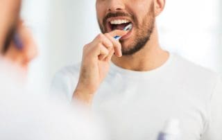 Patient brushing his teeth.