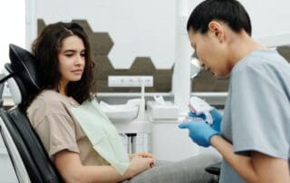 Dentist conducting a follow-up with a patient.