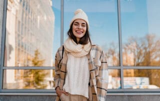 Happy and satisfied woman standing and showing her teeth.
