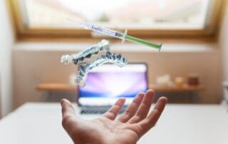 Hand holding a syringe with Invisalign aligners in the air against an ecstatic background.