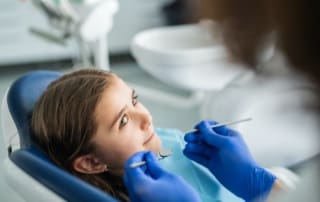 Child observing dentist during dental treatment.