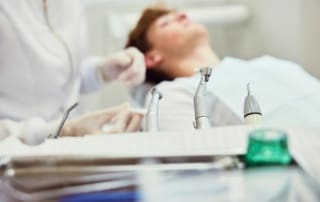 Dental instruments arranged in front of a patient.