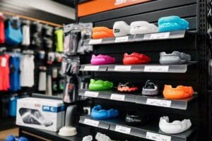 Assorted colorful mouth guards displayed on a table in a sports shop